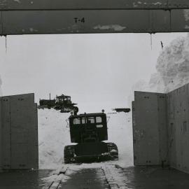 D-4  tractor backs out of new garage building at Byrd Station