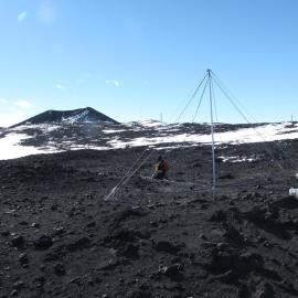 James Brundell re-ties the guy ropes with Erebus in the background