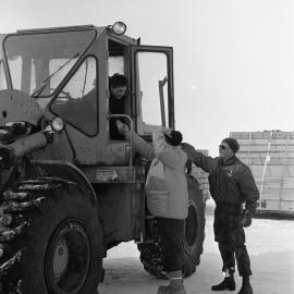Frank O'Flynn, Minister of Defence, talking to cargo handlers at ice runway