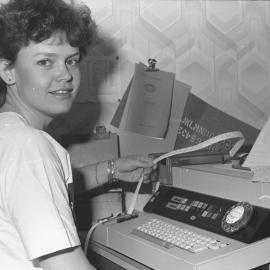 Jeanette May on telex machine