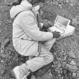 Jack McConchie from Victoria Uni working with personal computer in the field  