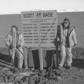 Biddy Harnett| and Heather Gilmor|e at Scott Base sign