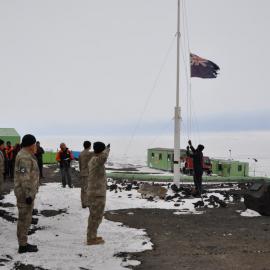 Able Marine Technician Sam Shannon lowering the summer flag