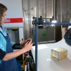 Antarctic Youth Ambassador Elana Hawke documents artifacts from a food depot removed from the Taylor Valley, thought to be 1970’s era.