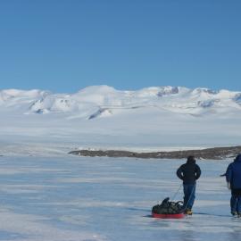Bryan and David Crossing Lake Wellman, with the Hatherton glacier in the background, Darwin Mountains