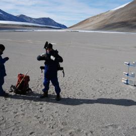 Jonathan Banks (left) and Ian Hogg (right) by a BSNE collector, looking west across Lake Colleen, toward the Garwood Glacier