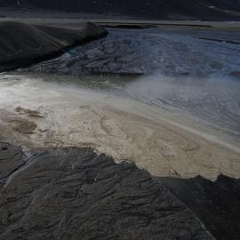 Organic foam on a glacier melt stream, northern lobe of the Joyce Glacier