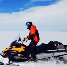 Tenby Powell on skidoo riding towards Mt Erebus