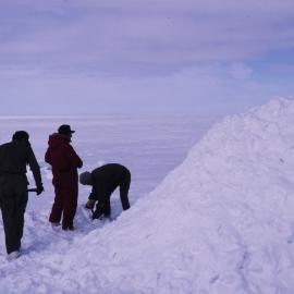 Building a snow mound on survival training