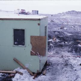Hut at edge of construction site Stage VI