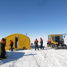 PB100 on slippery sled, airplane arriving in the background 