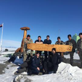 151111 NZDF Scott Base crew by Scott Base sign on Armistice Day2, Jeanine Begg