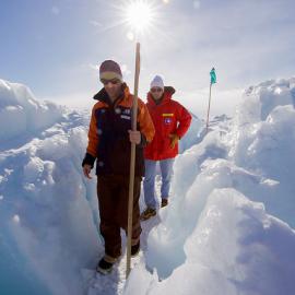 A guide leads U.S. Secretary of State John Kerry through the zone where ice crashes into land outside Scott Base,