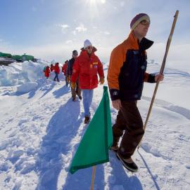 A guide leads U.S. Secretary of State John Kerry through the zone where ice crashes into land outside Scott Base
