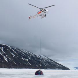 Helicopter with slingload at Cape Adare