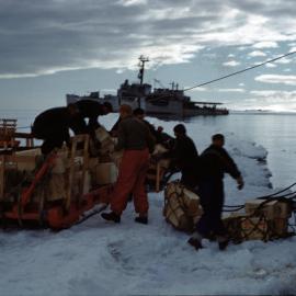 Gear is unloaded from ship TAE-IGY era