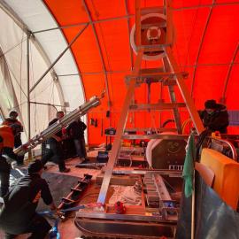 Preparing instrument on winch above borehole