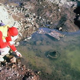 Rob at pond near McMurdo Stn with rubbish and algae mat