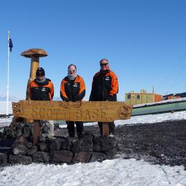K060 team in front of Scott Base sign
