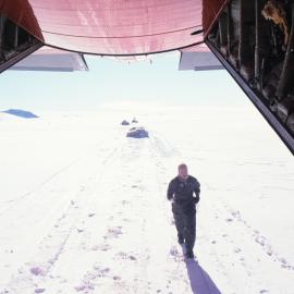 Off-loaded gear & crewman at back of ski Hercules 