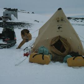 Chris Adams Shovels Snow onto Flaps of Polar Tent at Cape Evans
