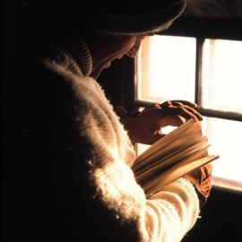 Graeme Ayres Reads a Book in Discovery Hut